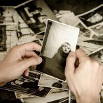 Black and white photographs in the hands of a man