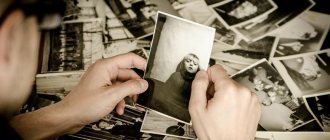 Black and white photographs in the hands of a man