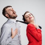 girl holding man&#39;s tie