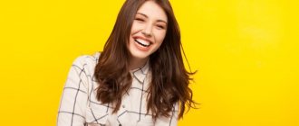 girl laughs on a yellow background