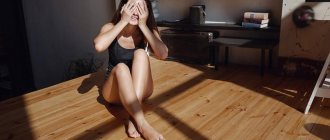 Girl in the room closes her eyes from the sun while sitting on the floor