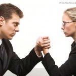 Man and woman arm wrestle