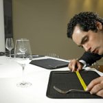 A man looks out for the length of the rug on the table