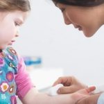 A child donates blood in a clinic