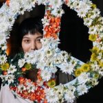 Woman standing with peace sign